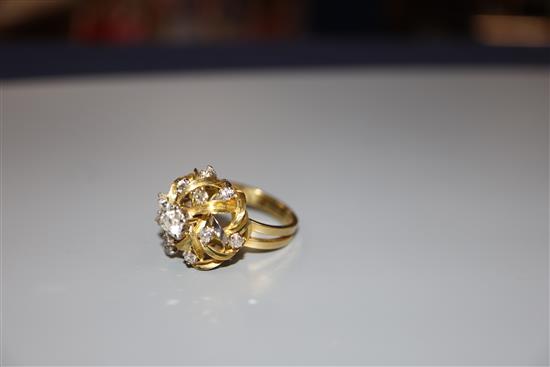 A modern 18ct and diamond set raised cluster dress ring, size N, gross 8.6 grams.